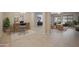 Inviting office space with modern desk, chair, decor, and open-concept view of the living area at 19351 E Apricot Ln, Queen Creek, AZ 85142