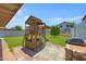 Backyard featuring a custom playhouse, ample green space, and a built-in grill at 2035 E Escuda Rd, Phoenix, AZ 85024