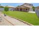 Spacious backyard with a playhouse for and a covered patio for entertaining at 2035 E Escuda Rd, Phoenix, AZ 85024