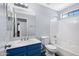Updated bathroom with blue vanity and white shower and toilet at 2035 E Escuda Rd, Phoenix, AZ 85024