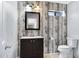 Updated bathroom with wood-look accent wall, single sink vanity and wood-look tile flooring at 2035 E Escuda Rd, Phoenix, AZ 85024