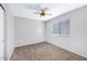 Simple bedroom features a ceiling fan, carpet flooring, and window for natural light at 2035 E Escuda Rd, Phoenix, AZ 85024