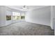 This bedroom has carpet flooring, a ceiling fan, and three large windows at 2035 E Escuda Rd, Phoenix, AZ 85024