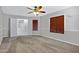 Spacious carpeted bedroom with neutral walls, wood blinds, and double doors leading to another room at 2035 E Escuda Rd, Phoenix, AZ 85024