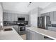 Modern kitchen features stainless appliances, speckled counters, and gray cabinets at 2035 E Escuda Rd, Phoenix, AZ 85024