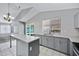 Bright kitchen with speckled countertops, gray cabinets, and sliding glass door to backyard at 2035 E Escuda Rd, Phoenix, AZ 85024