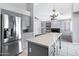 Open kitchen with stainless refrigerator and large island with speckled countertop at 2035 E Escuda Rd, Phoenix, AZ 85024