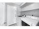 Bright laundry room features white washer and dryer units, and built-in shelving at 2035 E Escuda Rd, Phoenix, AZ 85024