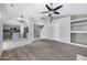 Open-concept living space with tile and carpet flooring, kitchen view, and modern lighting at 2035 E Escuda Rd, Phoenix, AZ 85024