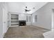 Bright living room featuring a fireplace, built-in shelving, and neutral carpeting at 2035 E Escuda Rd, Phoenix, AZ 85024