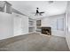 Open living room featuring a fireplace, built-in shelving, carpet, and ample natural light at 2035 E Escuda Rd, Phoenix, AZ 85024