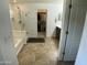 Bright bathroom with tile flooring, walk-in shower, soaking tub, and walk-in closet at 21141 E Pecan Ln, Queen Creek, AZ 85142