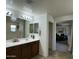 Bright bathroom with double vanity sinks next to the main bedroom at 21141 E Pecan Ln, Queen Creek, AZ 85142