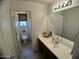 Clean bathroom with a single sink vanity and separate toilet area at 21141 E Pecan Ln, Queen Creek, AZ 85142