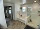 Bathroom featuring a separate shower and bathtub and decorative hanging plant at 21141 E Pecan Ln, Queen Creek, AZ 85142