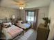 Bright bedroom with two twin beds, a ceiling fan, and closet at 21141 E Pecan Ln, Queen Creek, AZ 85142