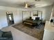 Spacious main bedroom with ceiling fan, neutral decor, and a walk-in closet at 21141 E Pecan Ln, Queen Creek, AZ 85142
