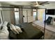 Inviting main bedroom with four poster bed, ceiling fan, and neutral color palette at 21141 E Pecan Ln, Queen Creek, AZ 85142