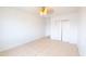 Minimalist bedroom with ceiling fan and ample closet space, creating a serene retreat at 3212 N 49Th Ln, Phoenix, AZ 85031