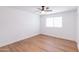 Bright bedroom with a ceiling fan and large window allowing for plenty of natural light at 3212 N 49Th Ln, Phoenix, AZ 85031