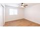Bright bedroom with white-painted brick wall, ceiling fan and natural light at 3212 N 49Th Ln, Phoenix, AZ 85031