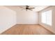 Bright, airy bedroom features wood-look floors, neutral walls, a ceiling fan, and a window at 3212 N 49Th Ln, Phoenix, AZ 85031