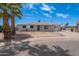Charming single-story home featuring a gray exterior, palm tree, and expansive front yard at 3212 N 49Th Ln, Phoenix, AZ 85031