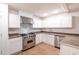 Modern kitchen boasts white cabinets, stainless steel appliances, and ample countertop space at 3212 N 49Th Ln, Phoenix, AZ 85031