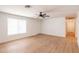 Bright, airy living room features wood-look floors, neutral walls, and a ceiling fan at 3212 N 49Th Ln, Phoenix, AZ 85031