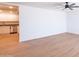 Bright, airy living room features wood-look floors, neutral walls, and open access to the kitchen at 3212 N 49Th Ln, Phoenix, AZ 85031