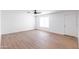 Bright, airy living room features wood-look floors, neutral walls, and a window at 3212 N 49Th Ln, Phoenix, AZ 85031