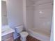 Bathroom with a single sink vanity, toilet, and a shower-tub combo with white tiled walls at 34940 N 30Th Ave, Phoenix, AZ 85086