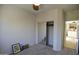 Cozy bedroom featuring carpet, mirrored closet, and an open door to a kitchen space at 34940 N 30Th Ave, Phoenix, AZ 85086