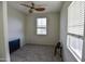 A carpeted bedroom with a ceiling fan, two windows providing natural light, and a modern design at 34940 N 30Th Ave, Phoenix, AZ 85086
