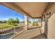 Enjoy amazing views from this balcony with white railing overlooking the pool and lush landscaping at 43324 W Desert Fairways Dr, Maricopa, AZ 85138