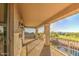 This is a spacious, covered balcony with views of the golf course and pool area at 43324 W Desert Fairways Dr, Maricopa, AZ 85138