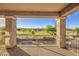 View from covered balcony showing beautiful landscape and swimming pool at 43324 W Desert Fairways Dr, Maricopa, AZ 85138