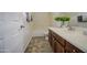 Well-lit bathroom featuring a single sink vanity and a walk-in shower at 43324 W Desert Fairways Dr, Maricopa, AZ 85138