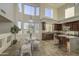 Bright breakfast nook with a large window, modern lighting, and access to the kitchen at 43324 W Desert Fairways Dr, Maricopa, AZ 85138