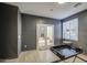 This stylish den is connected by glass doors to a carpeted room with fireplace at 43324 W Desert Fairways Dr, Maricopa, AZ 85138
