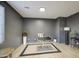 This stylish den offers recessed lighting and light wood laminate flooring at 43324 W Desert Fairways Dr, Maricopa, AZ 85138