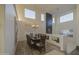 Bright dining room boasts high ceilings, wood floors, and a stylish chandelier at 43324 W Desert Fairways Dr, Maricopa, AZ 85138