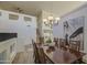 Spacious dining area features stylish lighting, seating for eight, and modern decor at 43324 W Desert Fairways Dr, Maricopa, AZ 85138