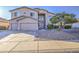 Two-story home with a neutral stucco exterior, three-car garage, and rock landscaping at 43324 W Desert Fairways Dr, Maricopa, AZ 85138