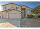 Two-story home with three-car garage and desert landscaping, offering curb appeal at 43324 W Desert Fairways Dr, Maricopa, AZ 85138
