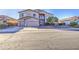 Two-story home with a three-car garage, desert landscaping, and inviting curb appeal at 43324 W Desert Fairways Dr, Maricopa, AZ 85138