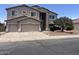 Two-story home with a neutral stucco exterior, three-car garage, and tidy landscaping at 43324 W Desert Fairways Dr, Maricopa, AZ 85138