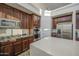 Bright kitchen featuring stainless steel appliances, dark wood cabinets and a center island at 43324 W Desert Fairways Dr, Maricopa, AZ 85138