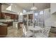 Bright kitchen with tall ceilings, stainless steel appliances, a center island, and an adjacent dining area at 43324 W Desert Fairways Dr, Maricopa, AZ 85138