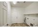 This laundry room has a utility sink, shelving, and a tile floor at 43324 W Desert Fairways Dr, Maricopa, AZ 85138